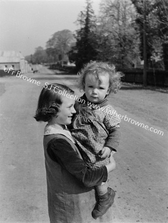 GIRL WITH CHILD IN ARMS